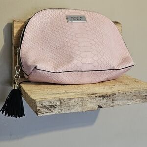Victoria's Secret pink snakeskin embossed cosmetic bag with a black tassel.